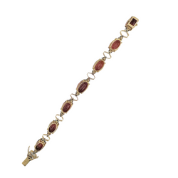 Articulated bracelet in yellow gold, platinum, garnets and diamonds