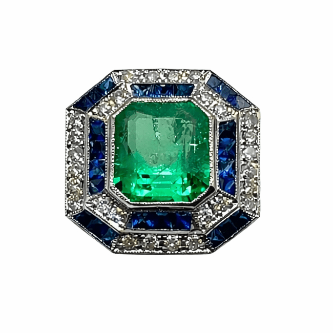 Bague Cocktail en or blanc, émeraude, saphirs et diamants - Castafiore