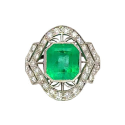 Bague Entourage Art Déco en platine, émeraude et diamants - Castafiore