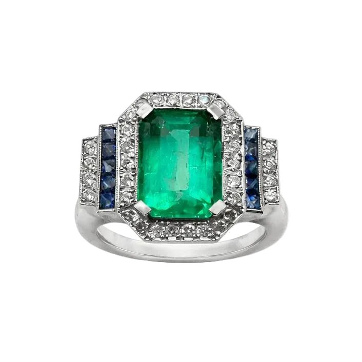 Bague Entourage en or blanc, émeraude, saphirs et diamants - Castafiore