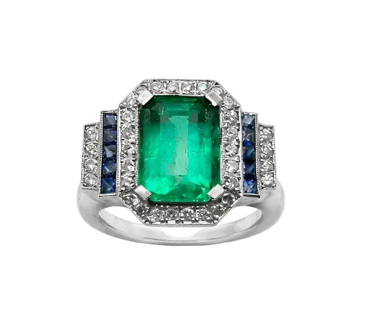 Bague Entourage en or blanc, émeraude, saphirs et diamants - Castafiore