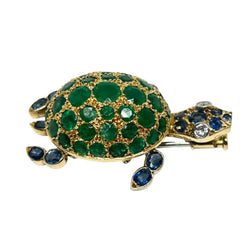 Broche GUBELIN en or jaune, émeraudes, saphirs et diamants