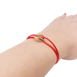 Bracelet CARTIER "Trinity" trois ors sur cordon - Castafiore