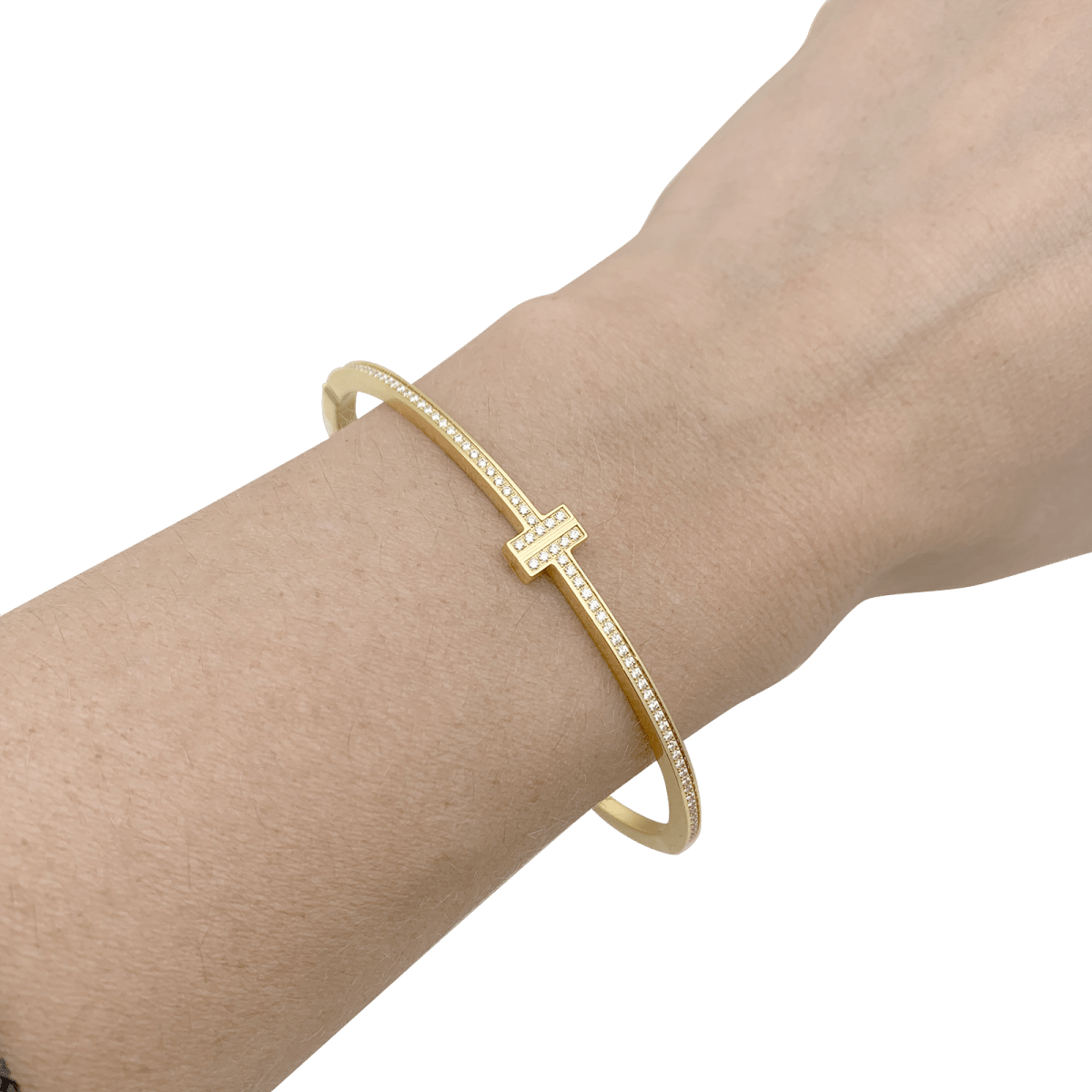 Bracelet Tiffany & Co., "Tiffany T" en or jaune et diamants. - Castafiore