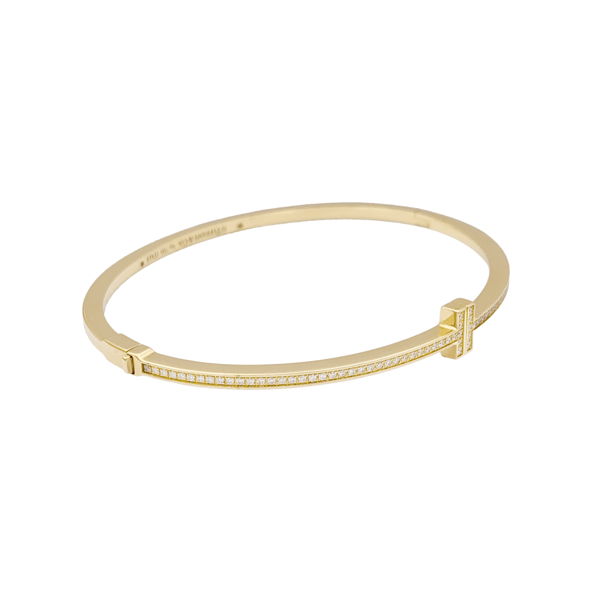 Bracelet Tiffany & Co., "Tiffany T" en or jaune et diamants. - Castafiore