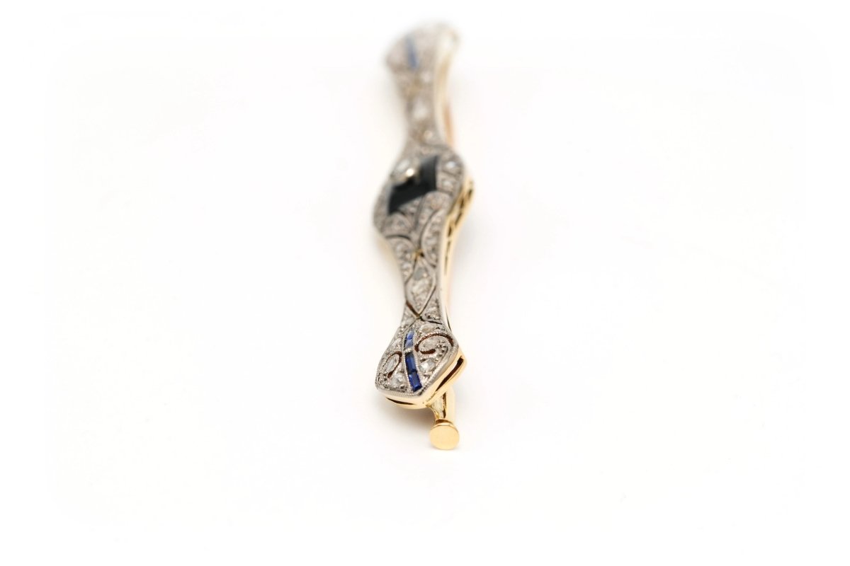 Broche Barrette en or blanc, or jaune, onyx, saphirs et diamants - Castafiore
