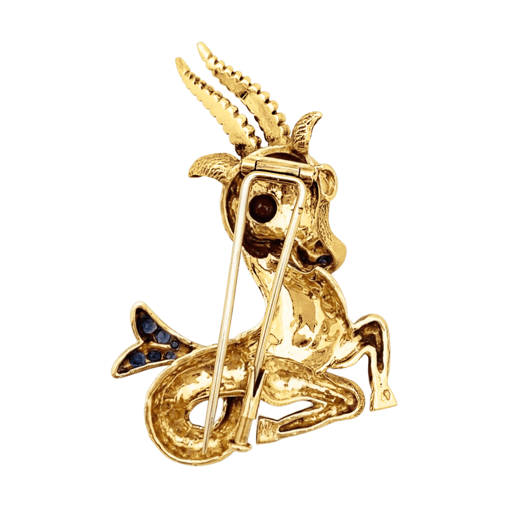 Broche Clip en or jaune, rubis et saphirs - Castafiore