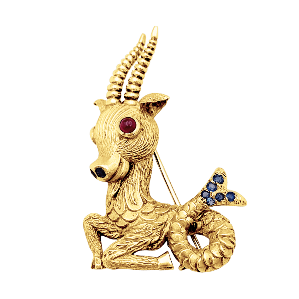 Broche Clip en or jaune, rubis et saphirs - Castafiore