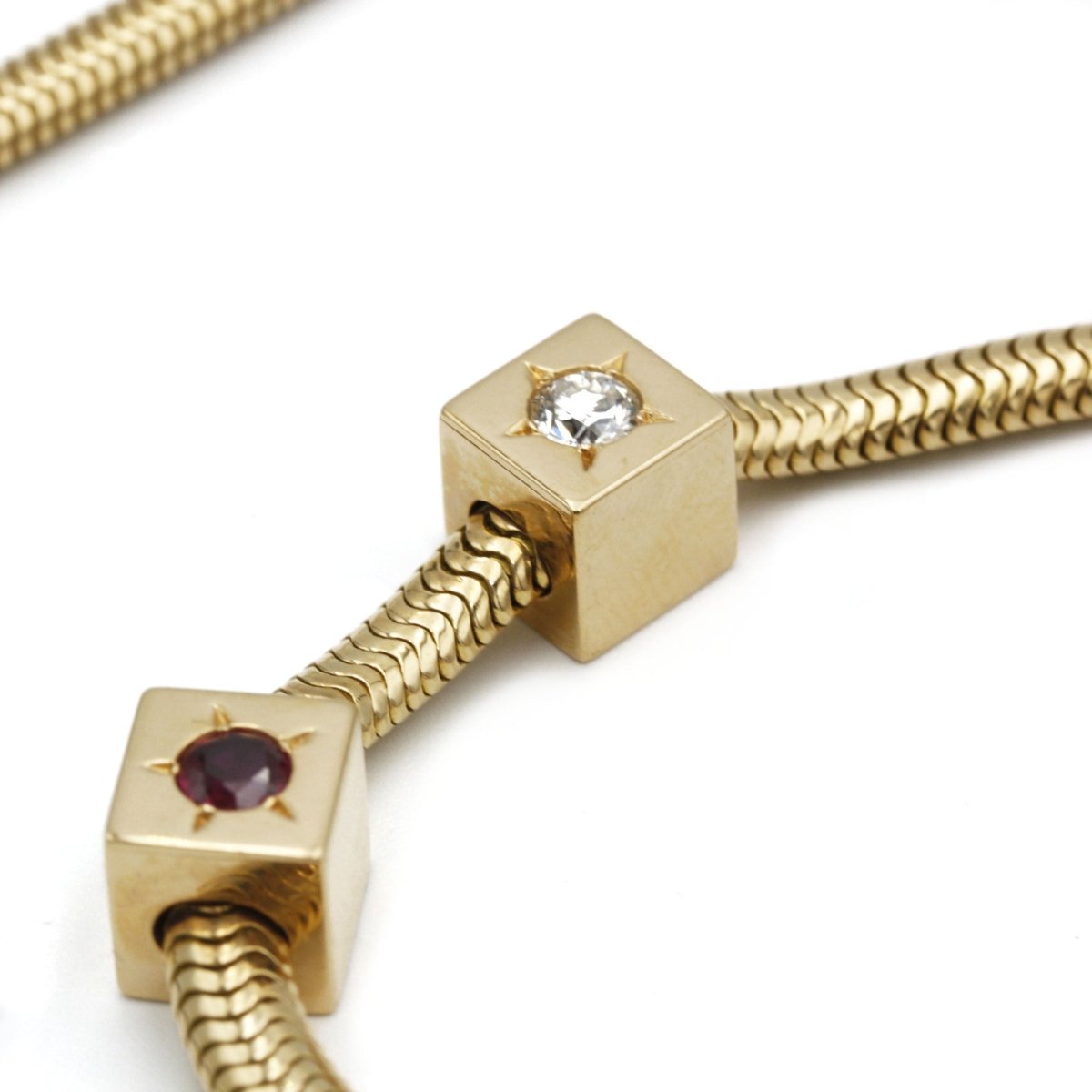 Collier Bracelet Souple Tubogas MELLERIO en or jaune, rubis et diamants - Castafiore