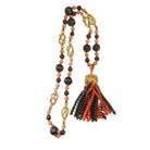 Collier CHAUMET "Pompon" en or jaune, corail et hématite - Castafiore