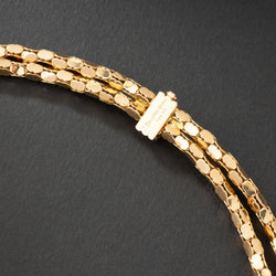 Collier en or jaune 18K à deux rangs, signé MELLERIO. - Castafiore