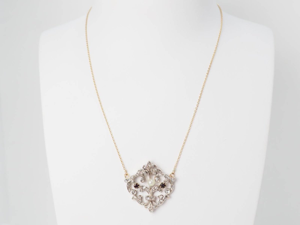 Collier volutes en or jaune et argent, grenat diamants et perle - Castafiore
