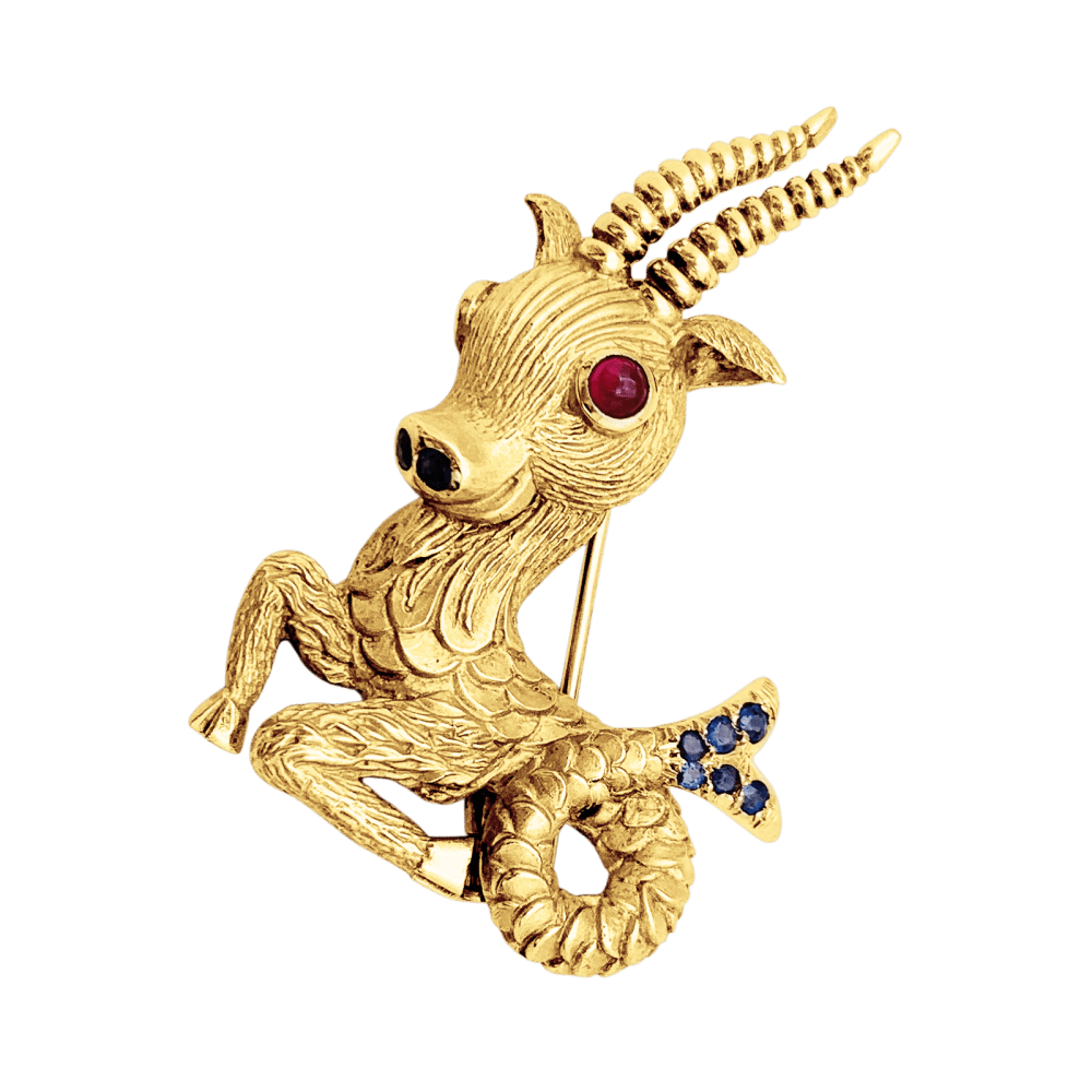 Broche-clip, "Capricorne", or jaune, rubis, saphirs.