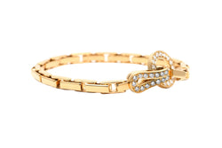 Bracelet Maille CARTIER "Agrafe" en or jaune et diamants