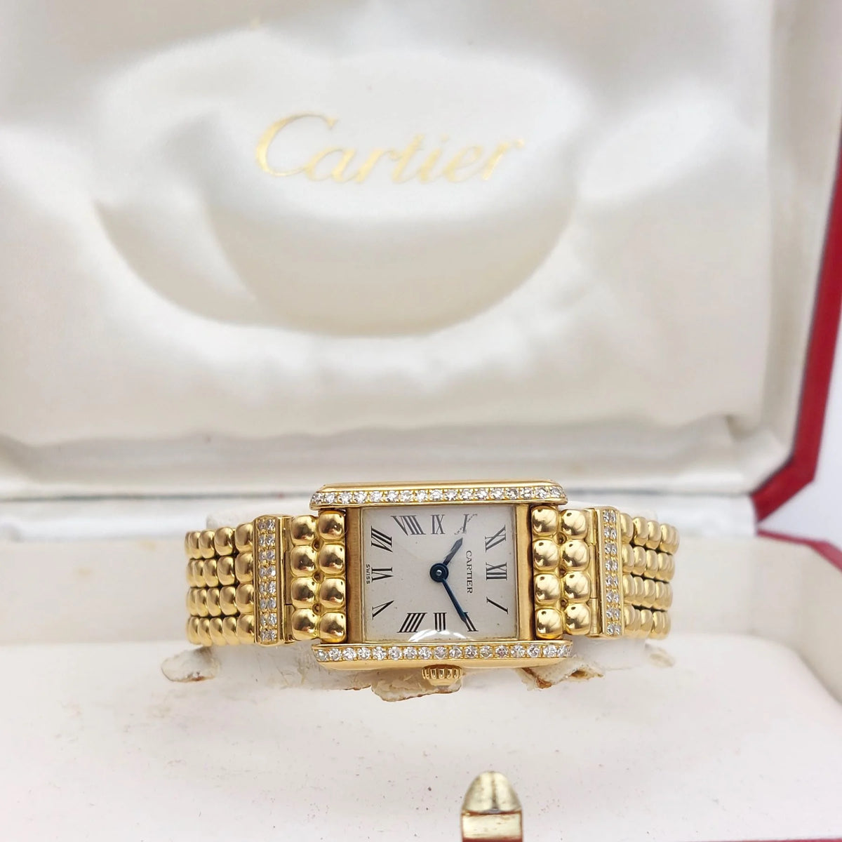 Montre CARTIER "Tank Louis Cartier Mini" en or jaune et diamants