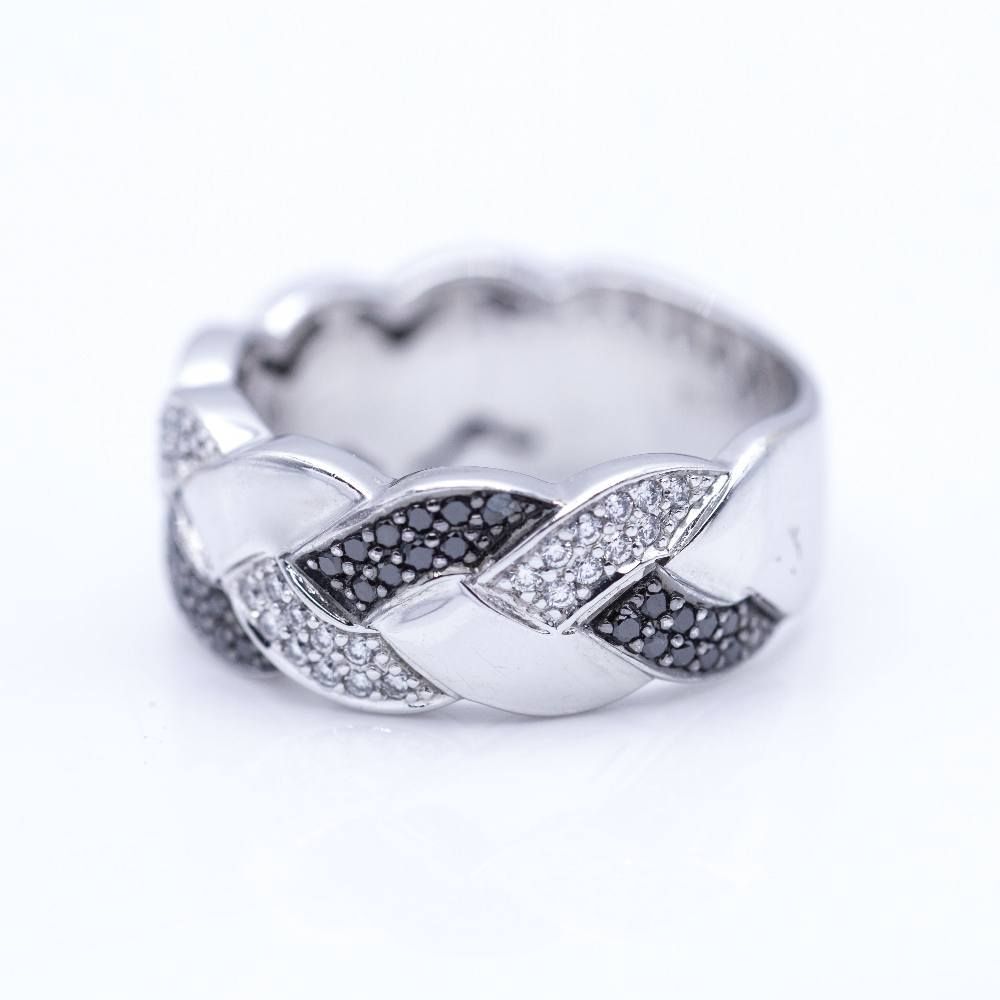 Bague tressée en or blanc avec diamants blancs et noirs.