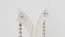 White gold and diamond dangling earrings