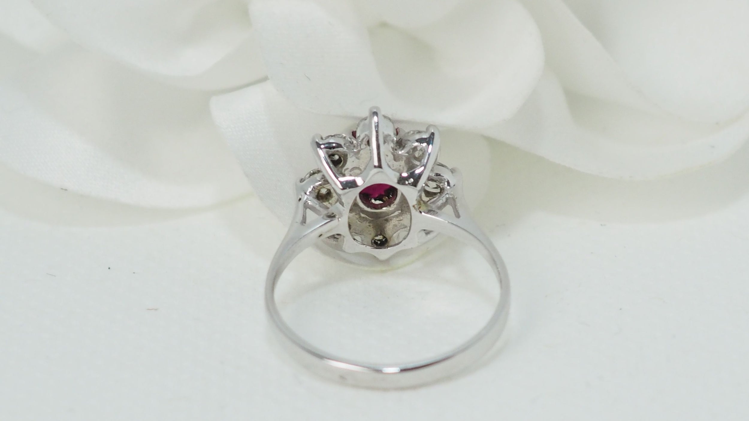White gold, oval ruby and diamond entourage ring