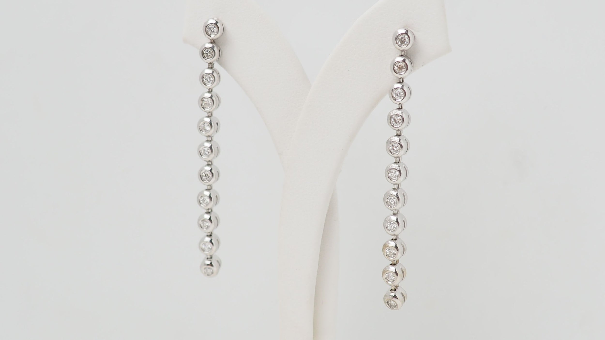 White gold and diamond dangling earrings
