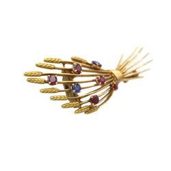 Broche Clip MELLERIO en or jaune, rubis et saphirs