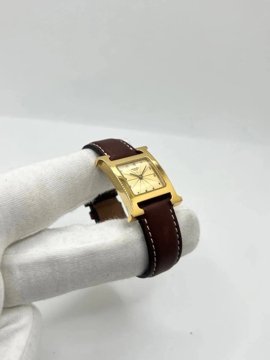Montre HERMÈS "Heure H" plaqué or, acier et cuir - Castafiore