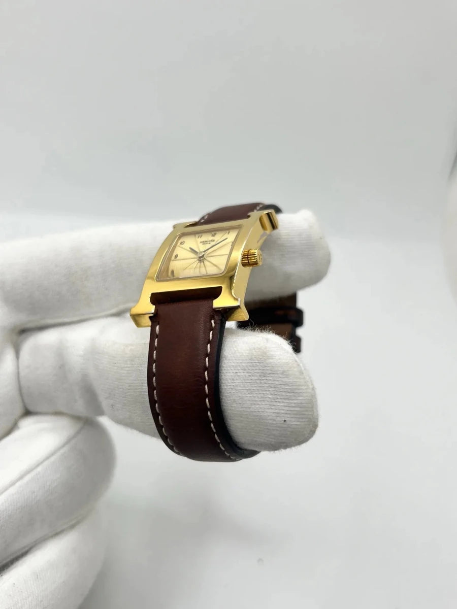 Montre HERMÈS "Heure H" plaqué or, acier et cuir - Castafiore