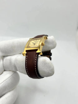 Montre HERMÈS "Heure H" plaqué or, acier et cuir - Castafiore
