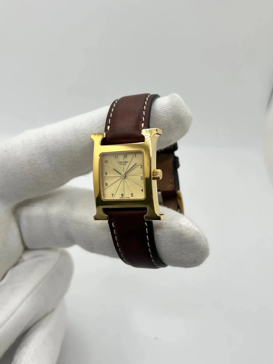Montre HERMÈS "Heure H" plaqué or, acier et cuir - Castafiore