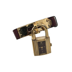 Montre HERMÈS "Kelly" en métal plaqué or et cuir - Castafiore