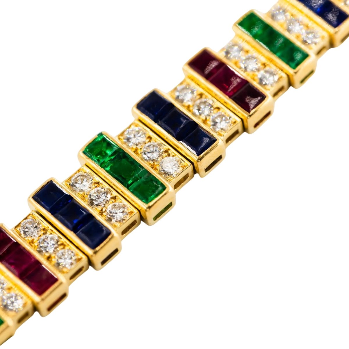 Parure CARTIER en or jaune, saphirs, émeraudes, rubis et diamants - Castafiore