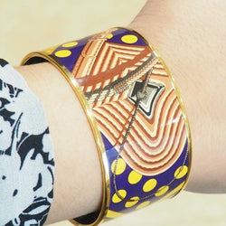 Bracelet Manchette HERMÈS en métal doré émaillé - Castafiore