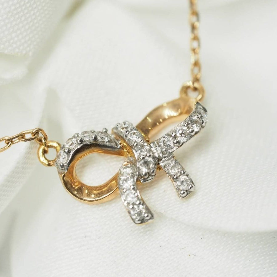 Collier avec motif nœud en or rose et diamants - Castafiore