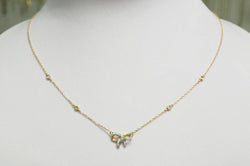 Collier avec motif nœud en or rose et diamants