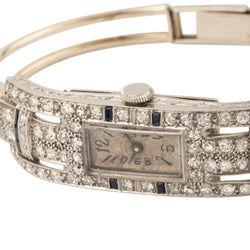 Montre de dame fine en or blanc, platine, brillants et onyx